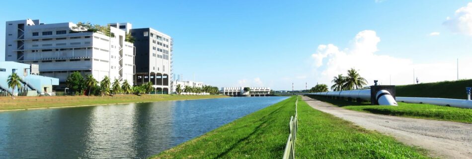 gray steel fence on green grass field