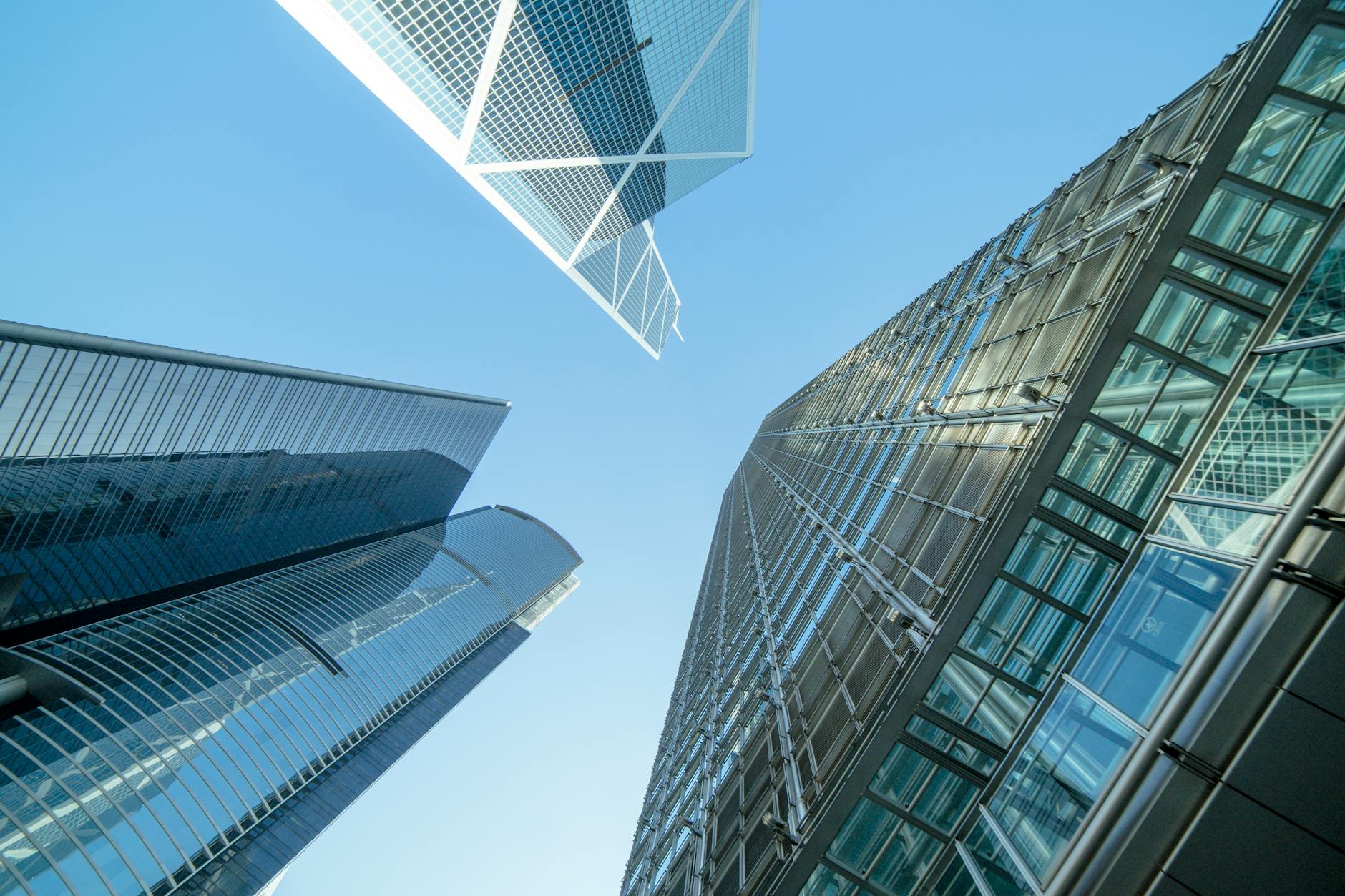 low angle photography of buildings under blue and white sky