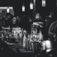 grayscale photography of bottles on top of table