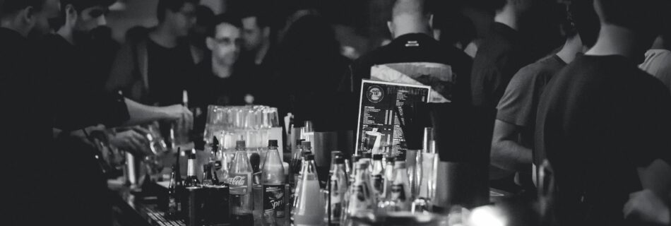 grayscale photography of bottles on top of table