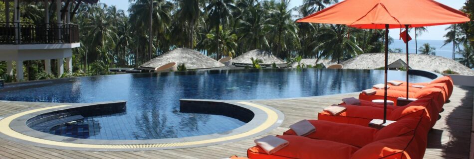 orange lounges near swimming pool