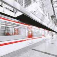 blurred motion of illuminated railroad station in city