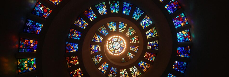 worms eye view of spiral stained glass decors through the roof