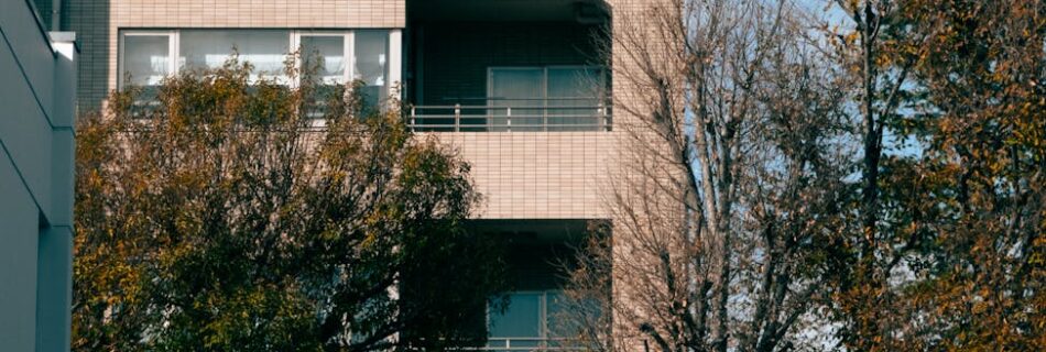 modern apartment building with autumn trees