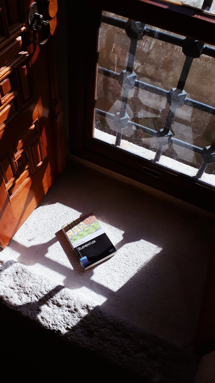 a book on the concrete floor near the door