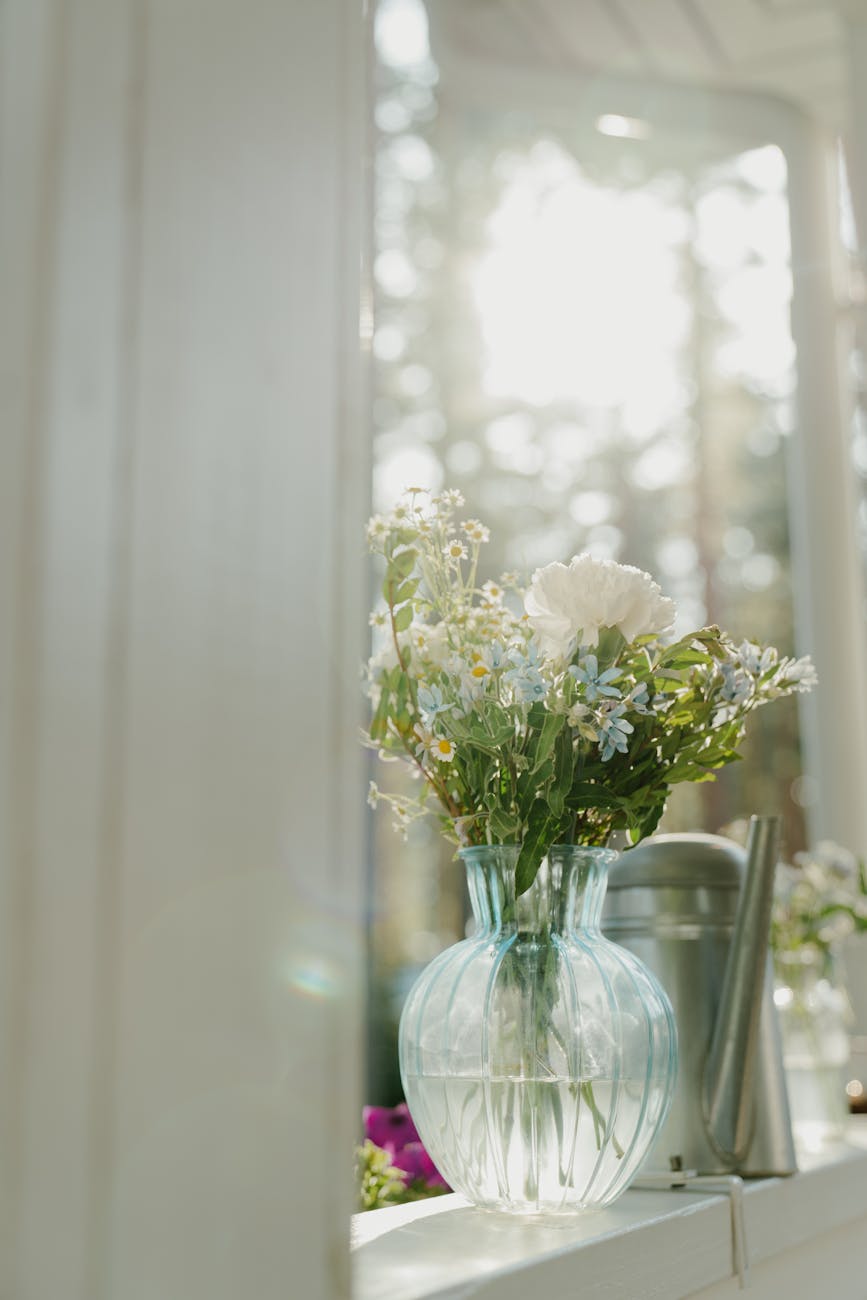 white flowers in clear glass vase