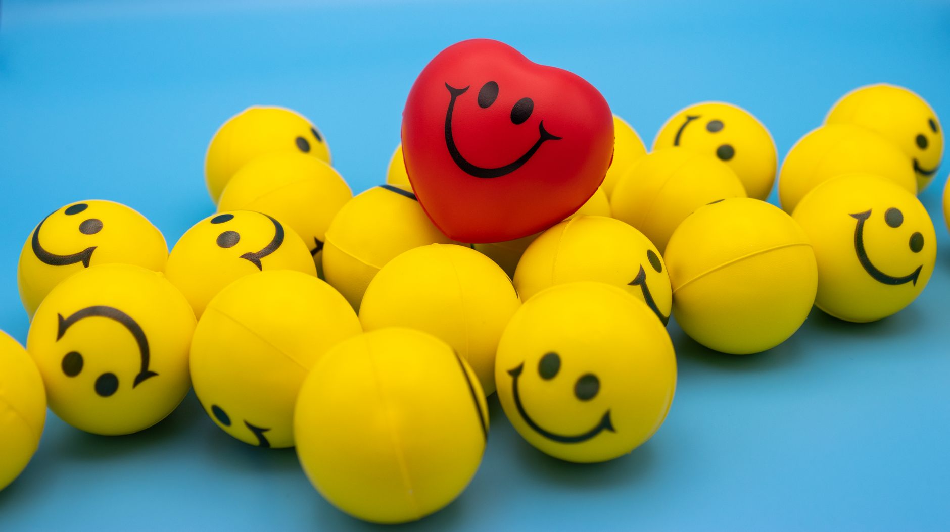 yellow and red smiley emoticon on blue surface